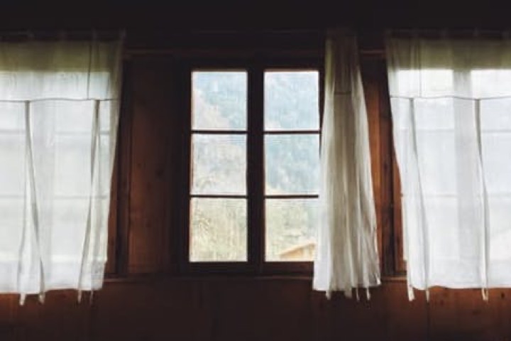 Curtains — soft white panels at a window